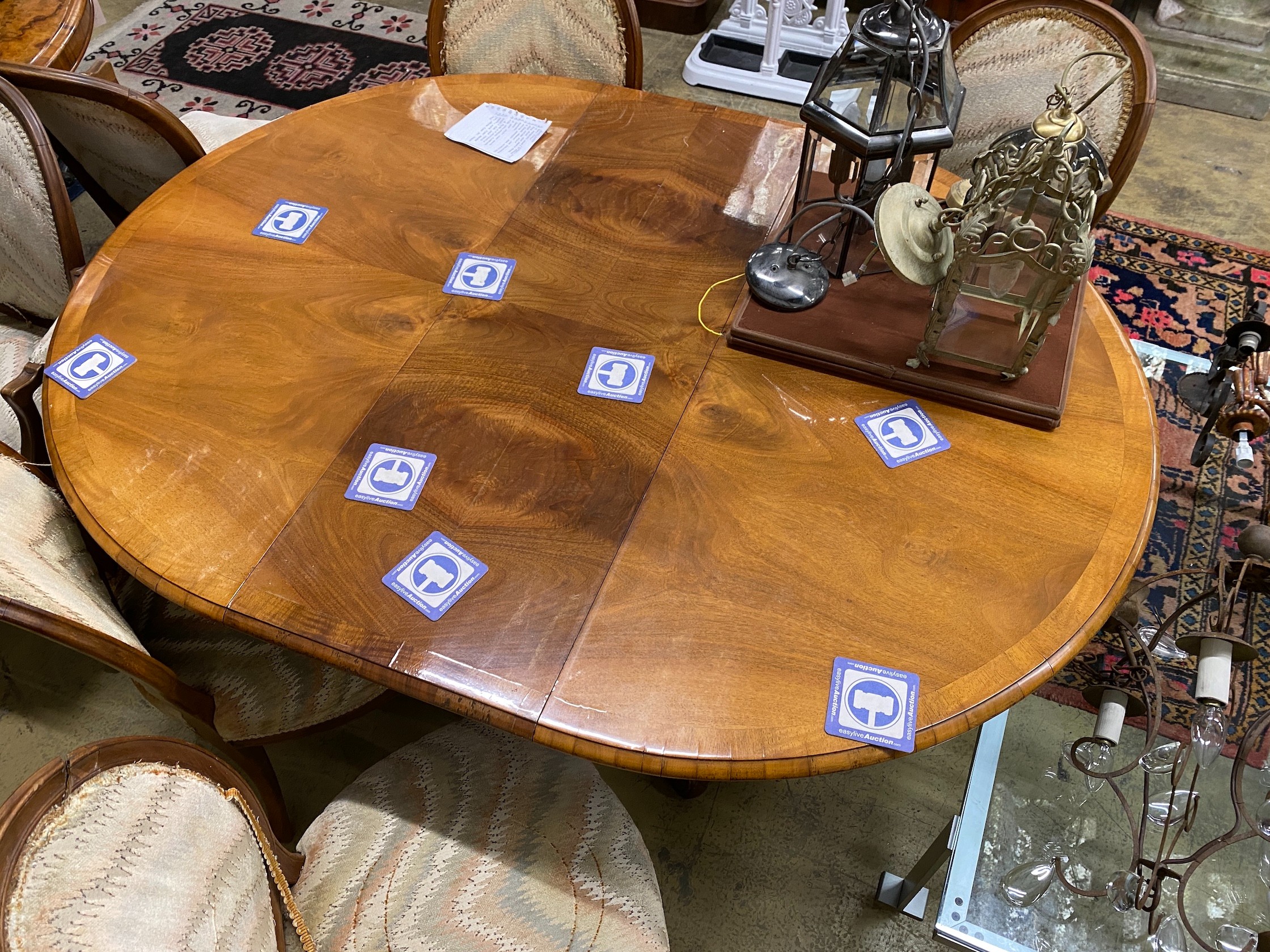 A Queen Anne Revival oval walnut extending dining table, length 162cm extended, one spare leaf, width 120cm, height 73cm together with eight Louis XVI style upholstered elbow chairs
